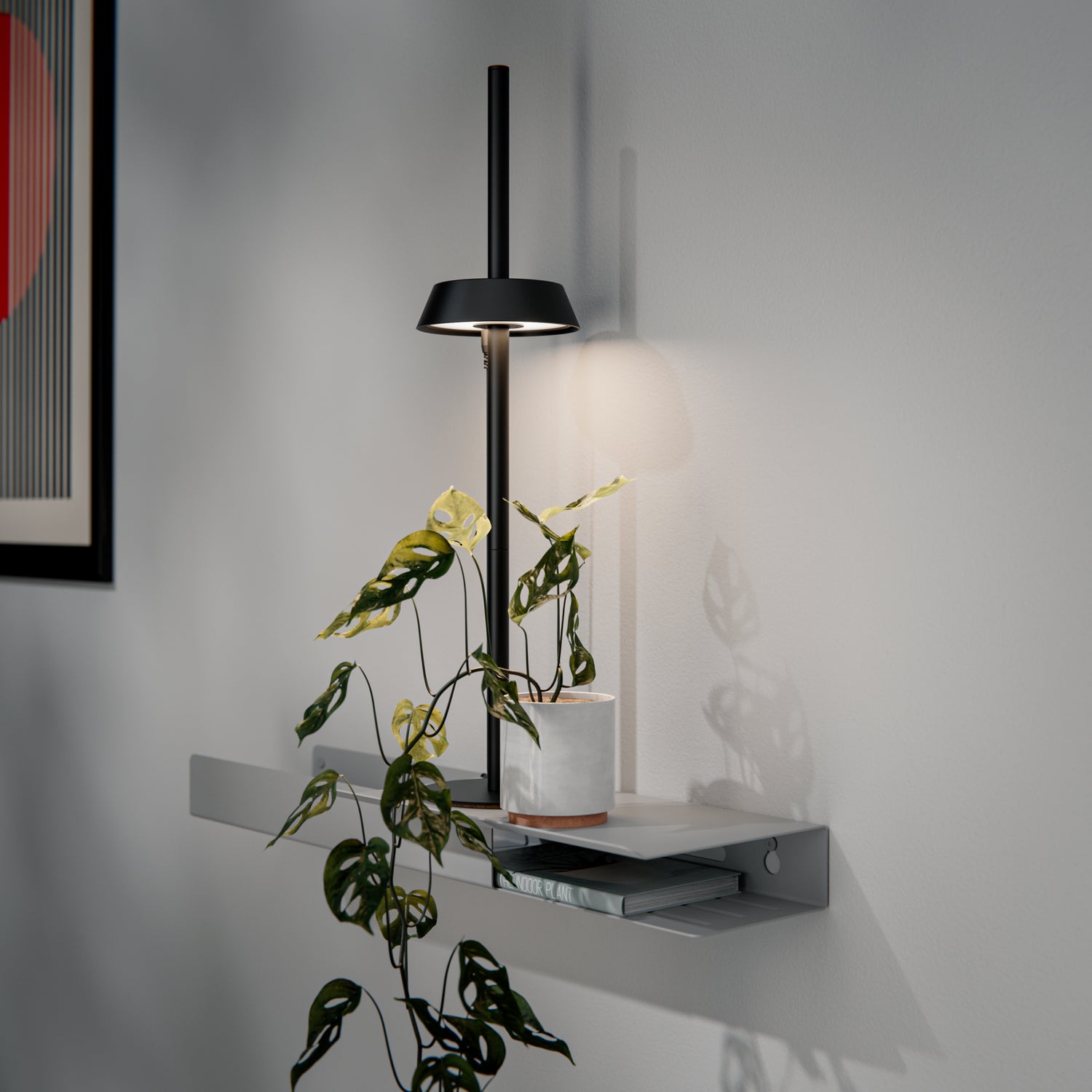 Modern grow light with a plant on a shelf against a neutral wall